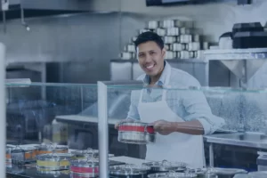 Smiling Filipino man working in a cafe.