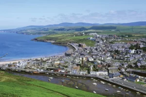 Aerial view of Peel on the Isle of Man with views over the town and of the hills in the background.